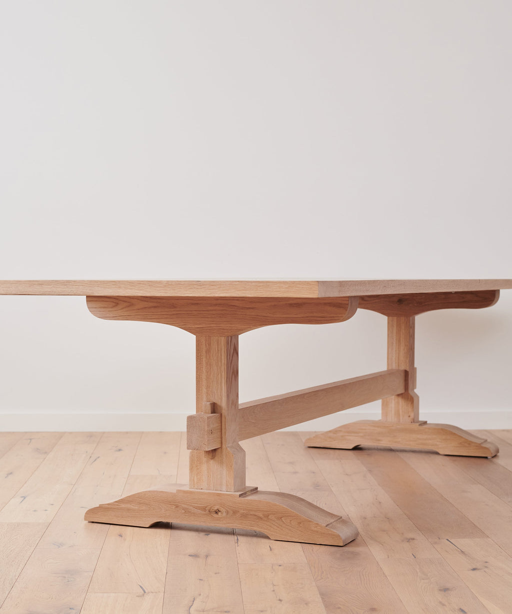 https://cdn.shopify.com/s/files/1/0565/1234/8333/products/JenniKayne_TrestleDiningTable_Oak-01.jpg?v=1762182598