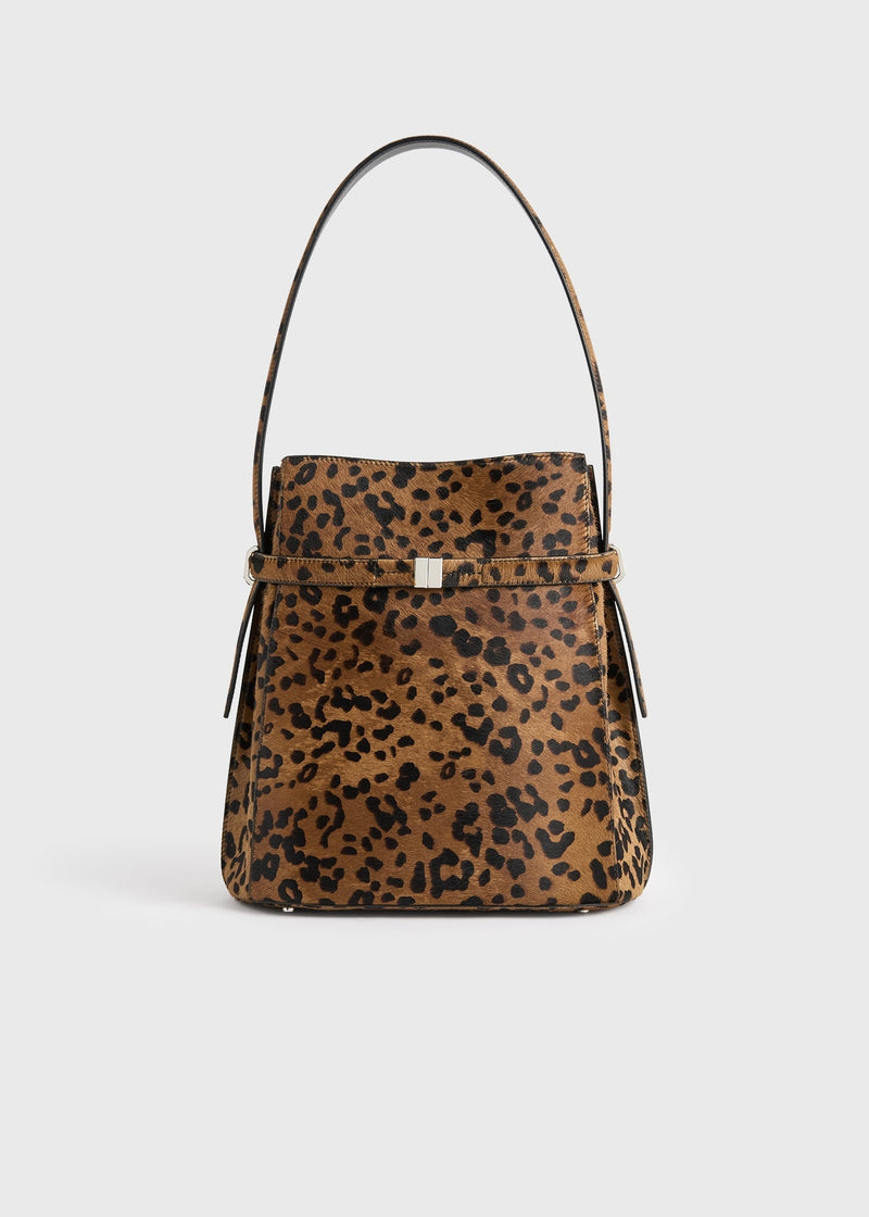 https://cdn.shopify.com/s/files/1/0452/1374/5316/files/TOTEME_FLATS_FW25__BAG_SEASONAL_254-WAL0048-LE0112_BELTED_PONY_HAIR_BUCKET_BAG_LEOPARD_front_GB.jpg?v=1752131298