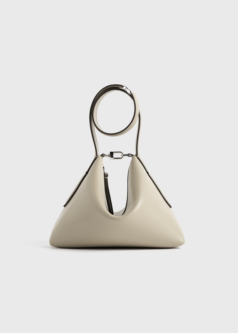 https://cdn.shopify.com/s/files/1/0452/1374/5316/files/TOTEME_FLATS_PF25_SEASONAL_BAG_253-WAL0090-LE0025_LEATHER_SCOOP_WRISTLET_FAWN_front_GB.jpg?v=1744812215