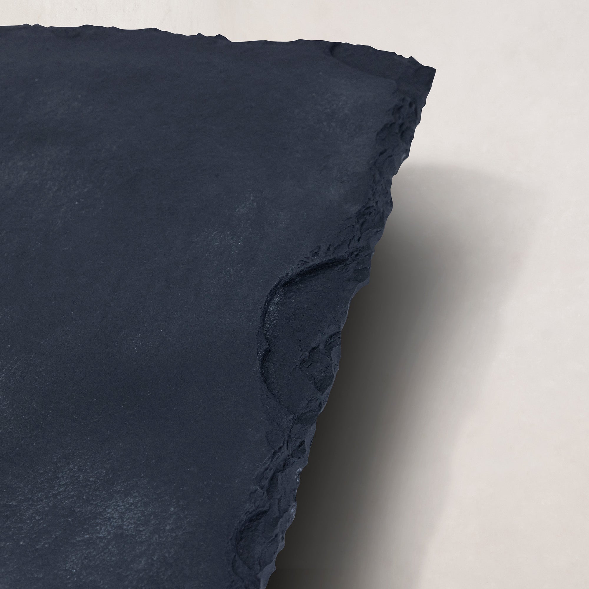https://cdn.shopify.com/s/files/1/0593/2217/1565/files/black-limestone-coffee-table-raw-edge3.jpg?v=1767639620