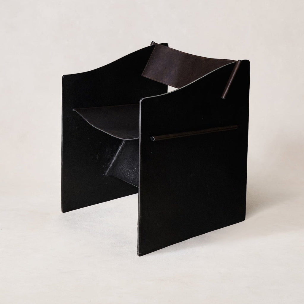 https://cdn.shopify.com/s/files/1/0593/2217/1565/files/brutalist-accent-chair-faux-black-leather.jpg?v=1758744227