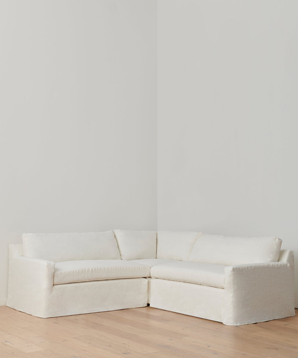 https://cdn.shopify.com/s/files/1/0565/1234/8333/products/linen-harbor-sectional-corner-ivory-1.jpg?v=1707868856
