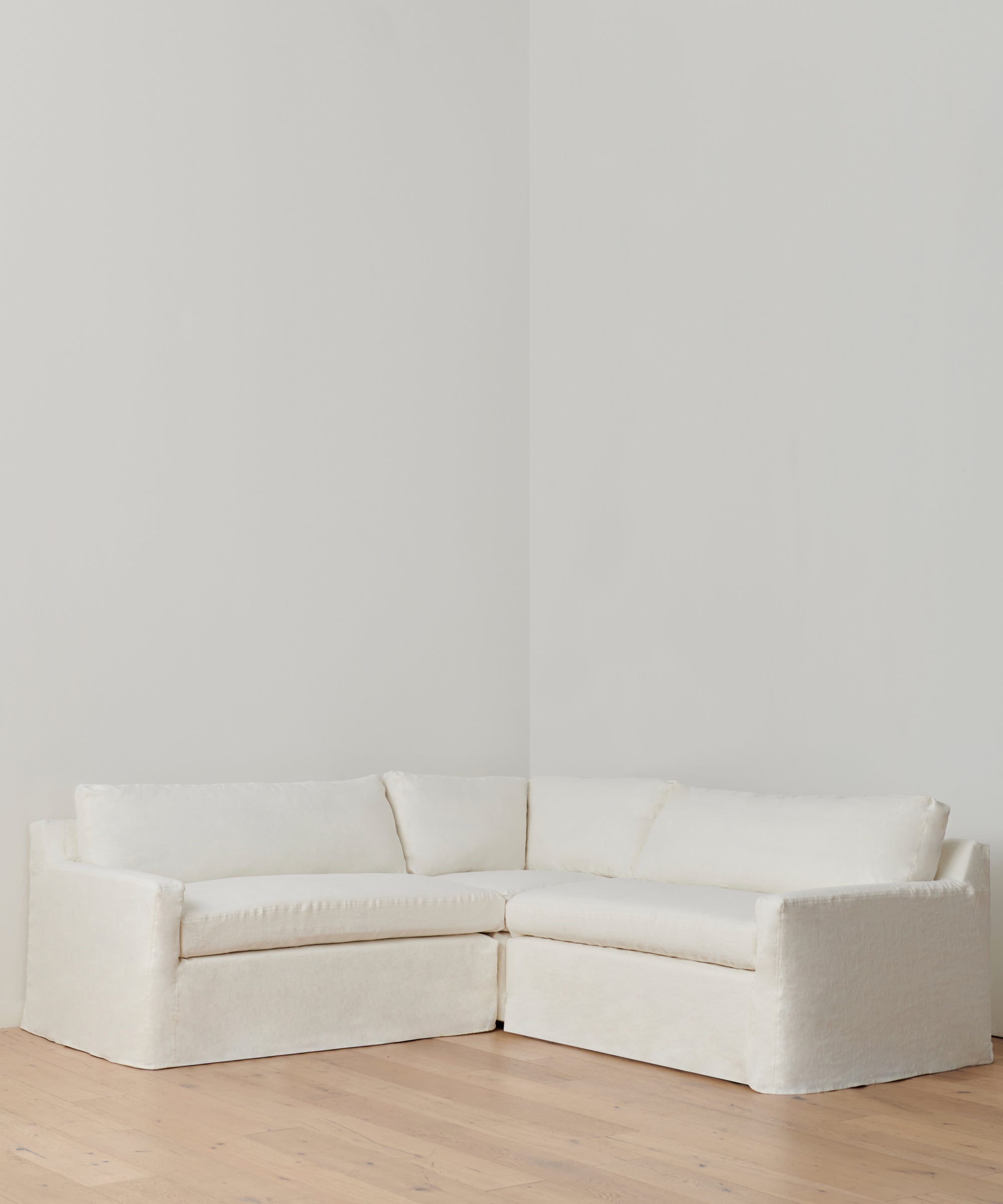 https://cdn.shopify.com/s/files/1/0565/1234/8333/products/linen-harbor-sectional-corner-ivory-1.jpg?v=1707868856