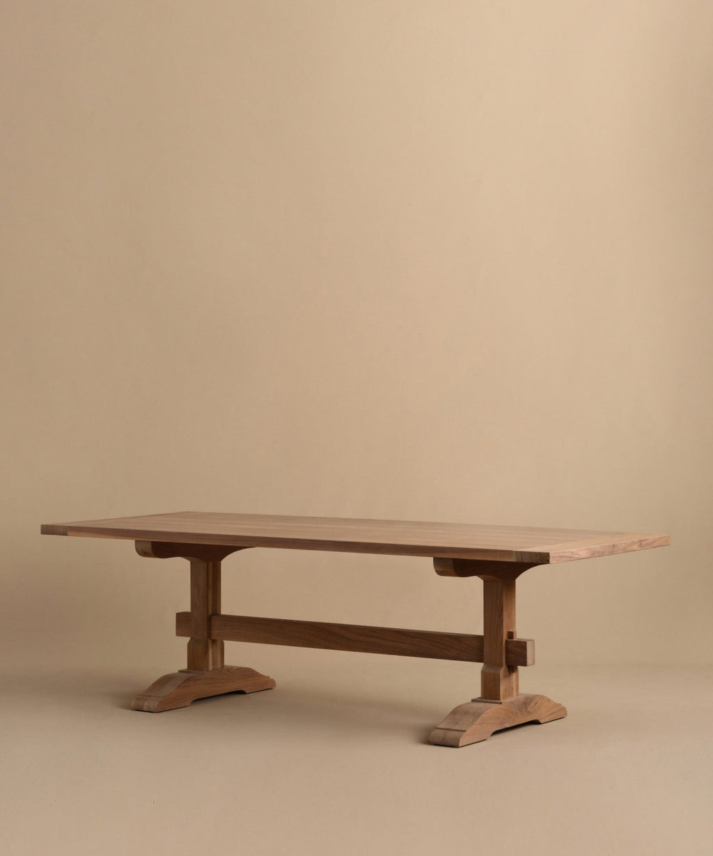 https://cdn.shopify.com/s/files/1/0565/1234/8333/files/trestle-dining-table-walnut-3.jpg?v=1760555101