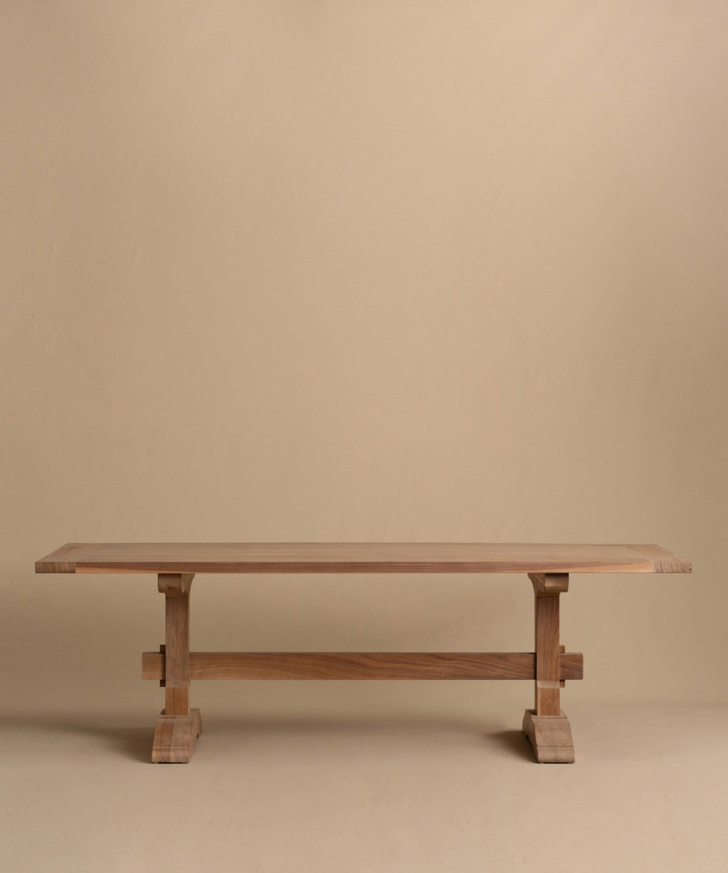 https://cdn.shopify.com/s/files/1/0565/1234/8333/files/trestle-dining-table-walnut.jpg?v=1760555094
