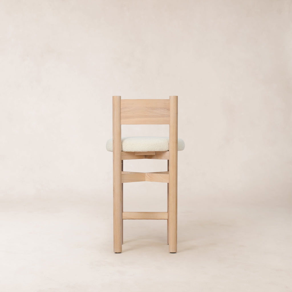 https://cdn.shopify.com/s/files/1/0593/2217/1565/files/white-boucle-wood-ounter-stool.jpg?v=1765133947