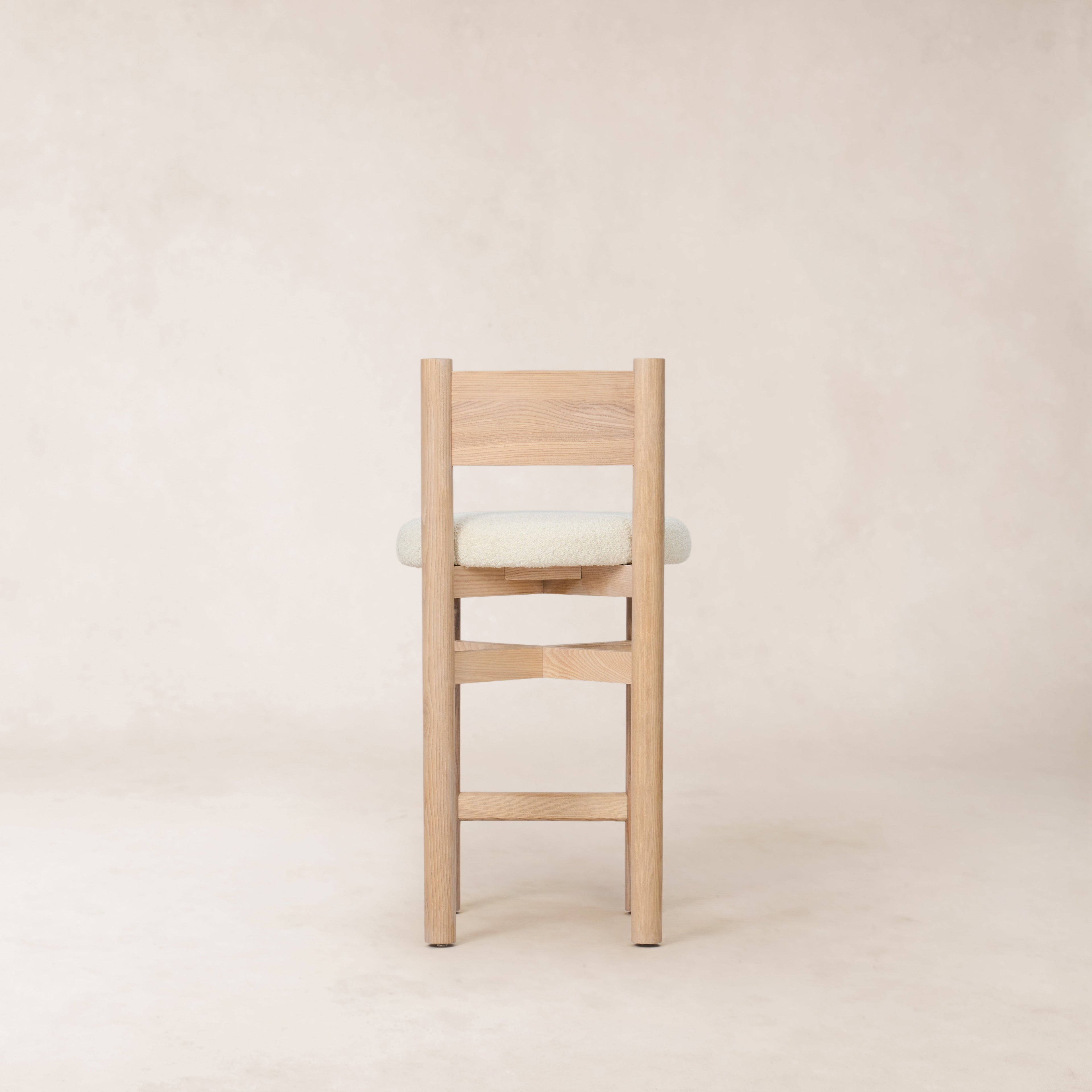 https://cdn.shopify.com/s/files/1/0593/2217/1565/files/white-boucle-wood-ounter-stool.jpg?v=1765133947